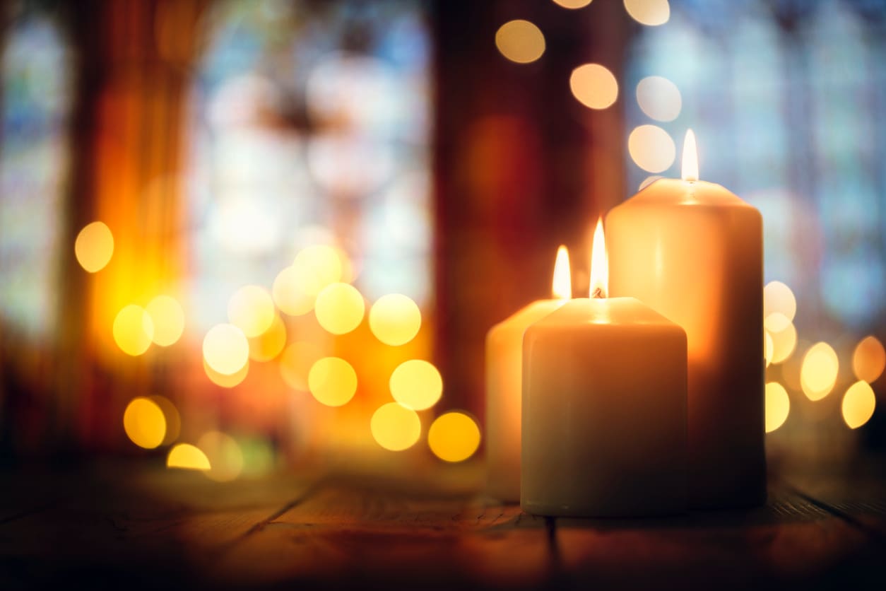 lit candles in a festively decorated church