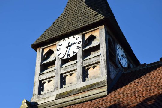 The unique wooden clock tower face - "To God be the glory"