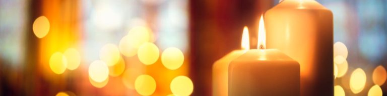 lit candles in a festively decorated church