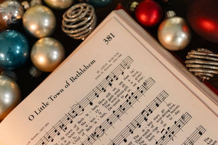 Carol sheet for 'O little town of Bethlehem' surrounded by baubles